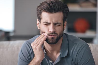 man with tooth pain in black rock