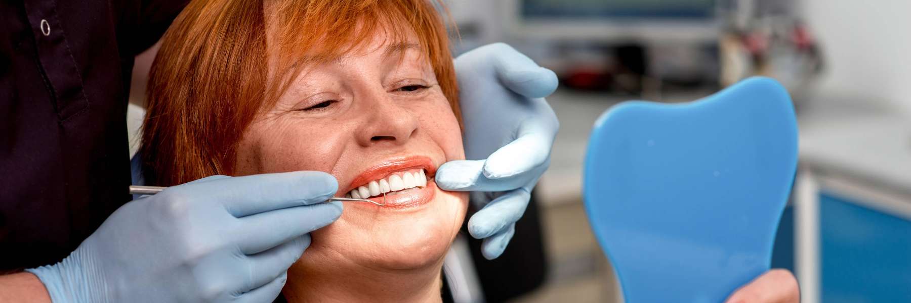 A woman in Black Rock checking her new whitened teeth